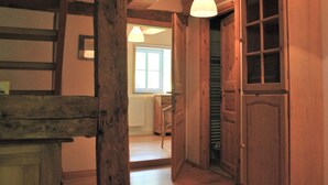 A wooden interior with a staircase, a door with glass panels, and a window allowing natural light. - Relaxing Watermill Hideaway (Heringen)