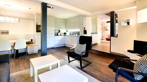 A modern living room with a sofa, a coffee table, and a dining area with a table and chairs. - Chic Mansion in Robertville (Waimes)