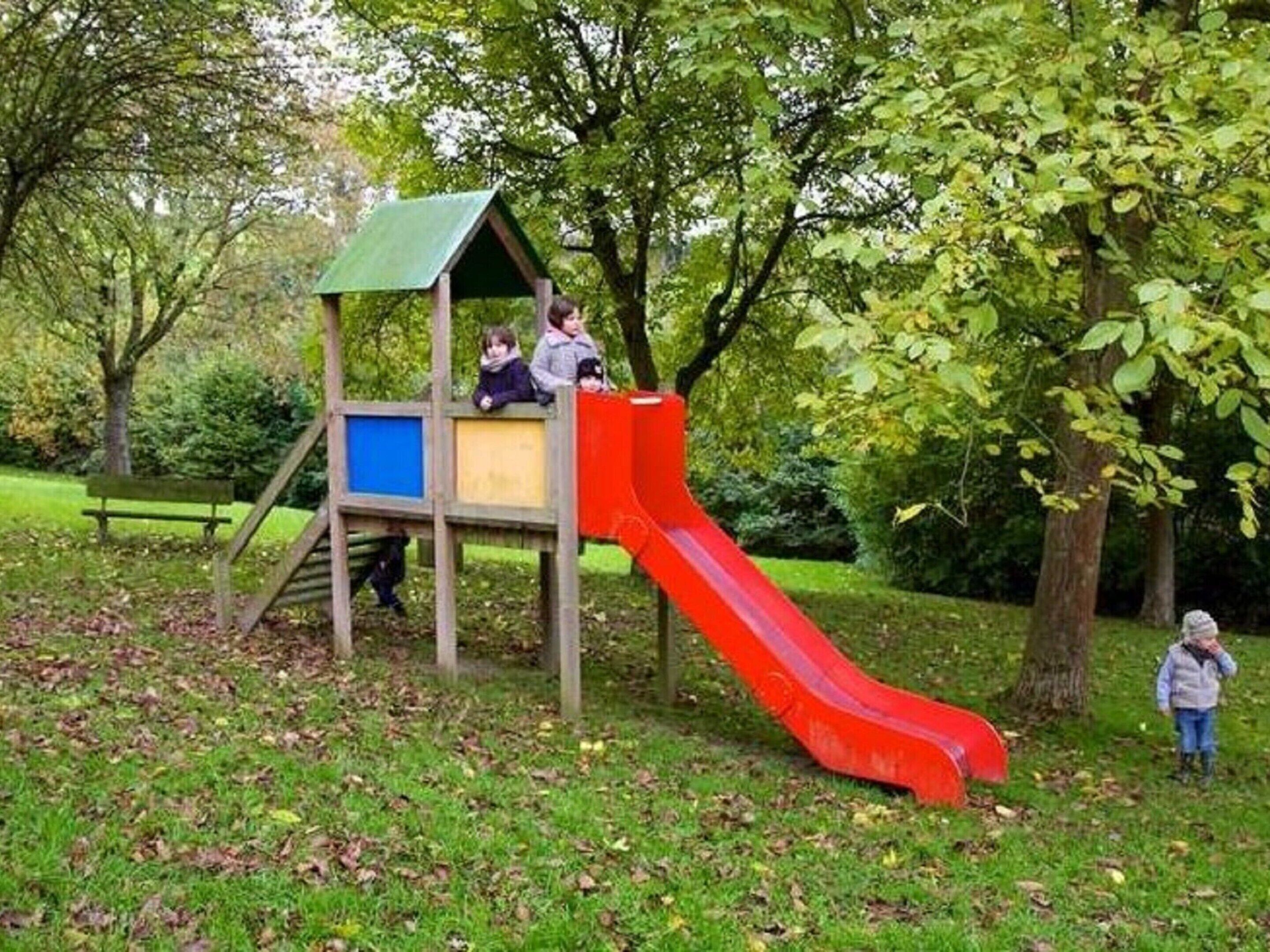 A playground with a slide and climbing area.