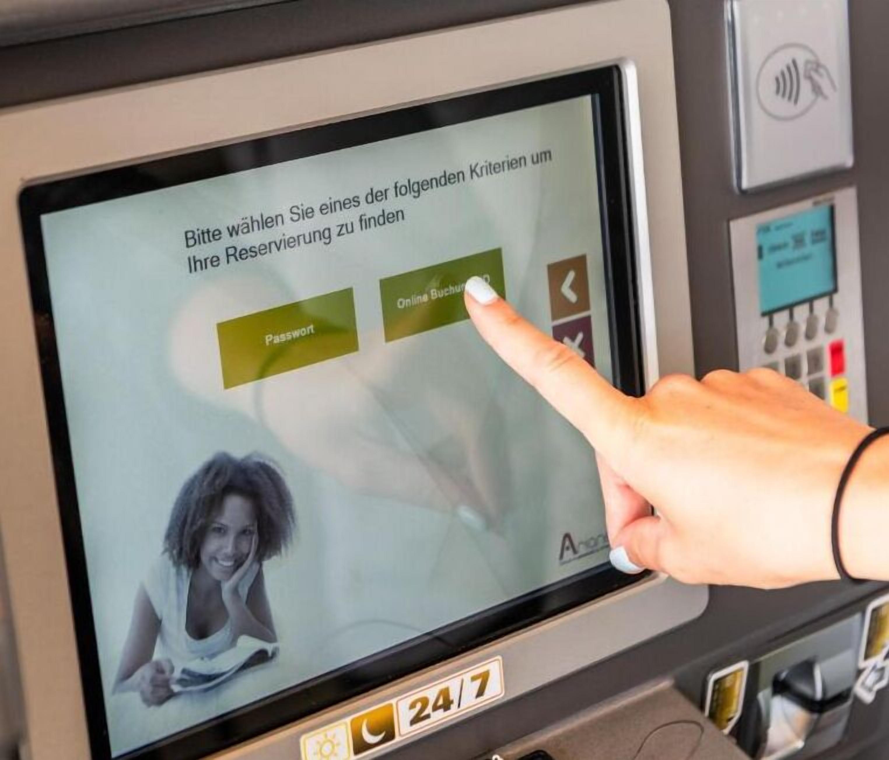 A digital screen with a user interface for a hotel reservation system, featuring a login option and a 24/7 service indicator.