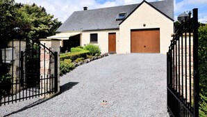 A two-story house with a gravel driveway leading to a gated entrance. - Beautiful Holiday Home in Durbuy With Garden (Durbuy)