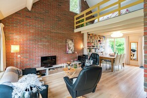House | Living room | Fireplace - Cozy Holiday Home with Hot Tub in Lauwersoog by Lake (Lauwersoog)