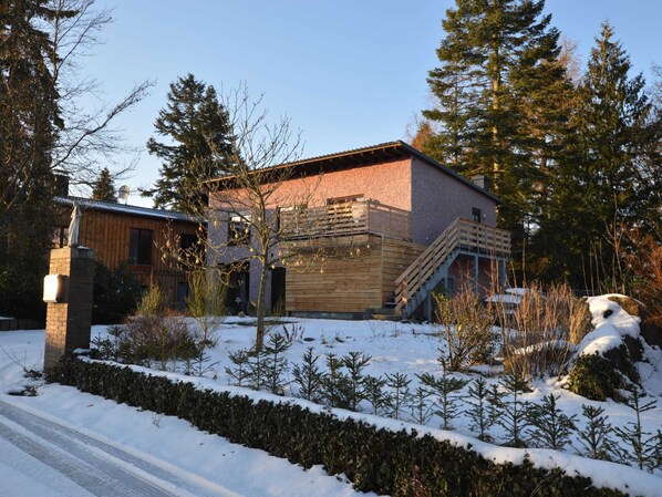 Stunning two-story building with a wooden staircase and balcony.