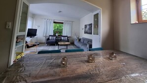 A living room with a sofa, chairs, a coffee table, and a TV. - Apartment in Willingen Near Ski Lift (Willingen)