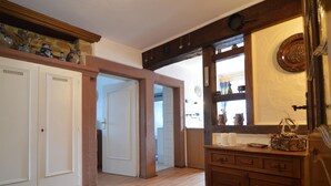 A spacious hallway with wooden flooring, a wooden cabinet with drawers, and a door leading to another room. - Apartment Welschbilling Near Trails (Welschbillig)