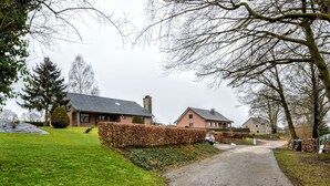 A rural road leading to a row of houses with a well-maintained lawn and hedges. - Peaceful Escape, Malmedy (Malmedy)