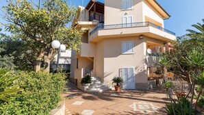 A multi-story residential building with a balcony, a staircase, and potted plants. - Simplistic Holiday Home in Sciacca near Horse Riding (Sciacca)