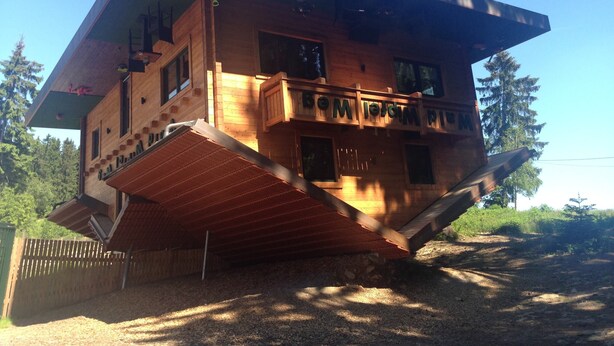 A wooden cabin with a sloped roof, a balcony, and a small porch. - Welcoming Chalet near Forest in Rohrnbach (Roehrnbach)