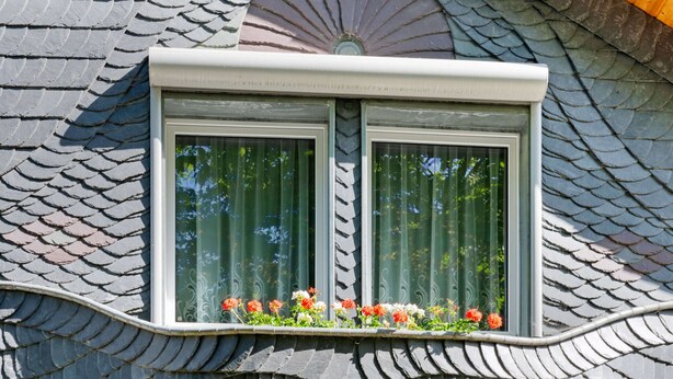 A building with a distinctive fish-scale roof and a window with a decorative frame. - Attractive Apartment in Rubeland in the Upper Harz (Oberharz am Brocken)