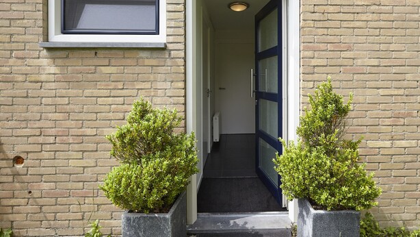 A building entrance with a door, a window, and two potted plants. - Holiday Home in Kortgene Near Lake Veere (Kortgene)