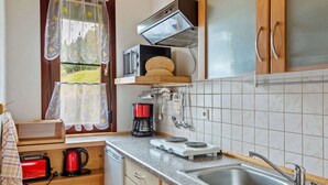 A compact kitchen with a sink, a coffee maker, a toaster, and a microwave. - Quiet Home Near Vessertal (Schleusegrund)