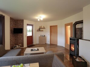 Cozy living space with a fireplace, flat-screen TV, and comfortable seating area.