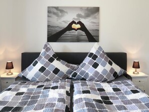 Cozy retreat with a neatly made bed and a romantic touch.