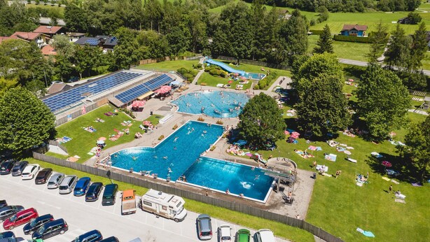 An aerial view of a resort with multiple swimming pools, a water slide, and a parking area. - Spacious Apartment in Mittersill near Ski Points (Mittersill)