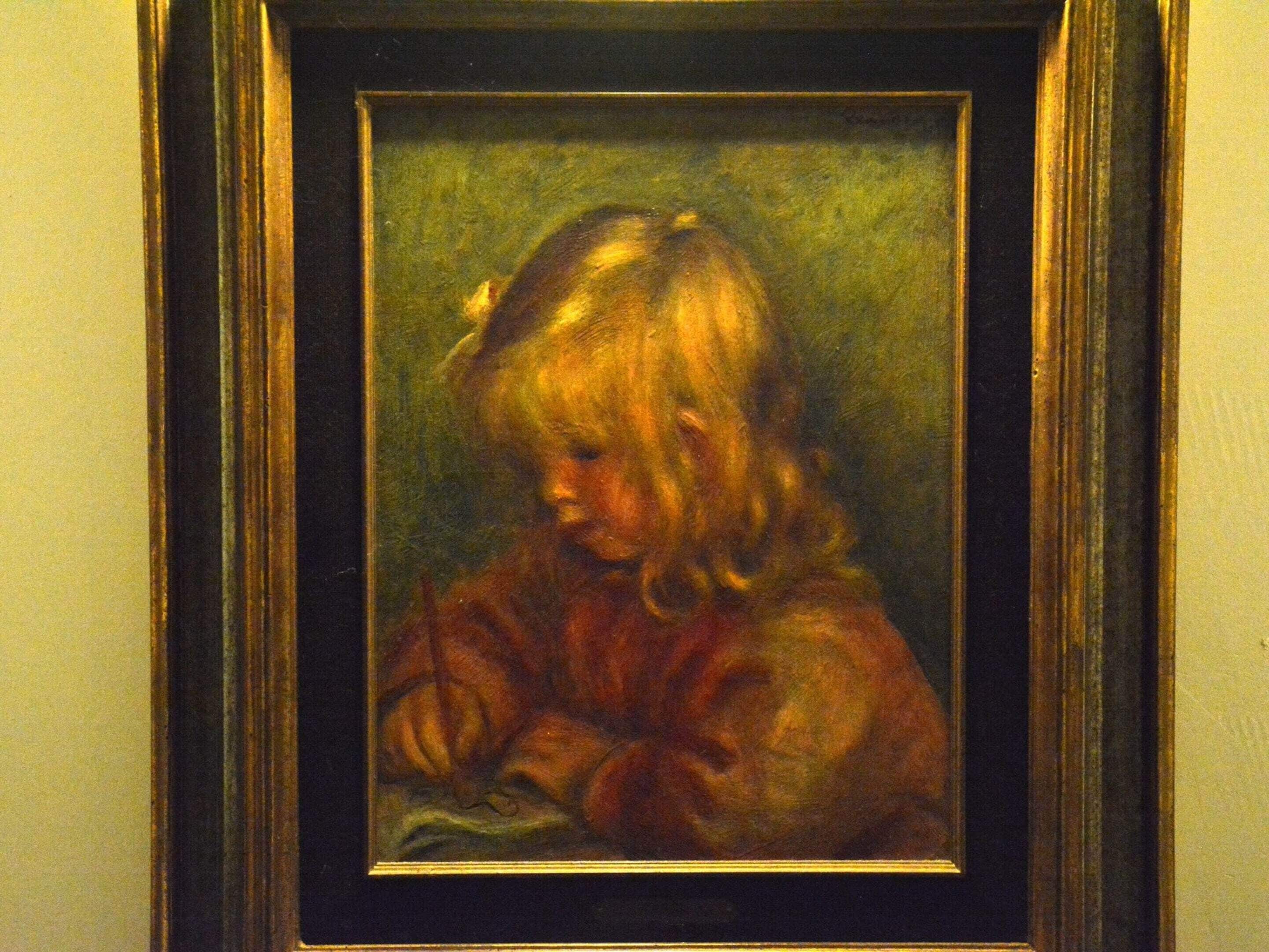 A framed portrait of a child with curly hair, set against a green background.