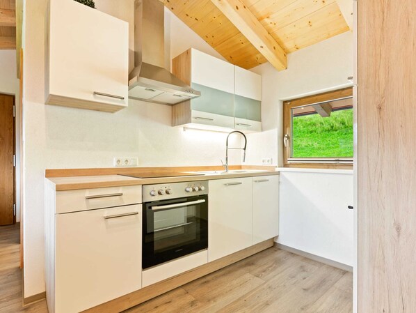 Apartment | Private kitchen | Microwave, coffee/tea maker, high chair