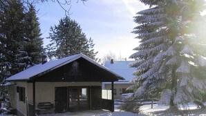 A small, single-story building with a sloped roof, surrounded by snow-covered trees. - Charming Holiday Home in Liebenscheid by Forest (Liebenscheid)