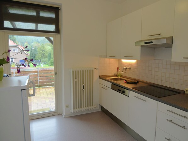 A modern kitchen with white cabinets, a stainless steel sink, and a built-in oven. - Holiday Flat in Bad Pyrmont With Balcony (Bad Pyrmont)