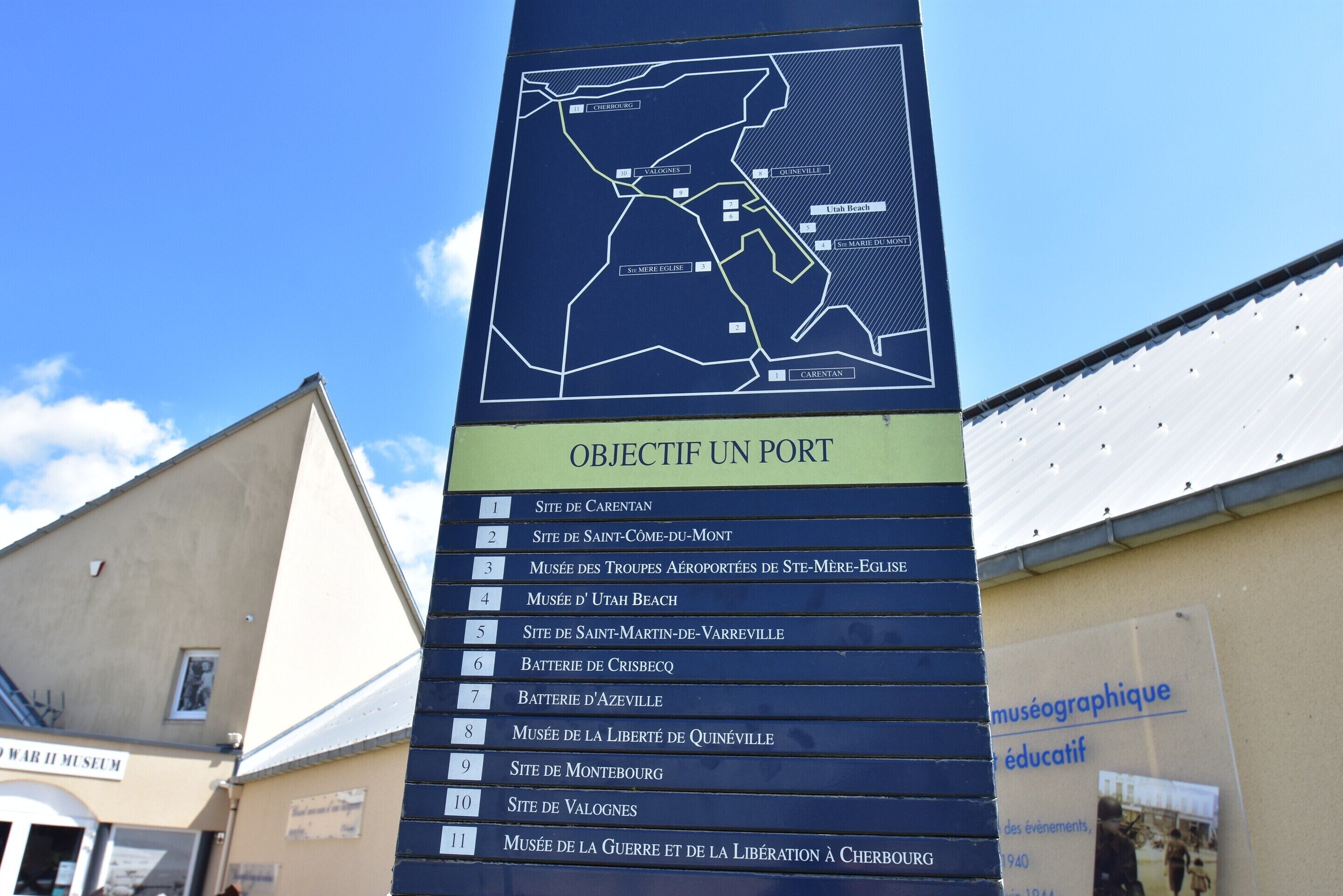 A sign with a map and a list of locations.
