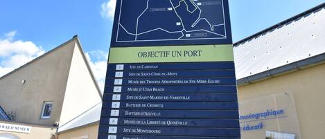 A sign with a map and a list of locations.