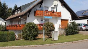 A two-story building with a balcony, a satellite dish, and a sign reading "Michael-Eckert-Str." - Cozy Apartment in Herrischried near Black Forest (Herrischried)
