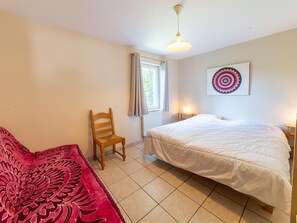 A bedroom with a bed, a chair, a window, and a wall-mounted artwork. - Forest-edge Hideaway, Bouillon (Bouillon)