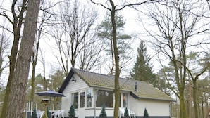 A house with a tiled roof, surrounded by trees and a grassy area. - Holiday Home in Stramproy Near Nature Reserves (Stramproy)