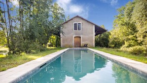 A swimming pool with a house in the background. - Former Train Station With Private Heated Swimming Pool & Fantastic Garden (Liglet)