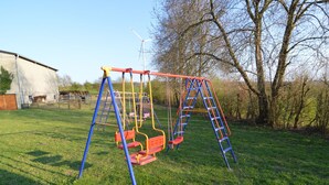 A playground with swings and a ladder.