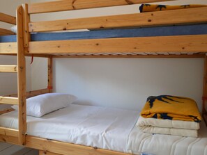 A bunk bed with a wooden frame and white bedding. - Comfy Apartment in Zendscheid near Forest (Zendscheid)
