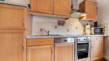 Apartment | Private kitchen | Fridge, coffee/tea maker, high chair