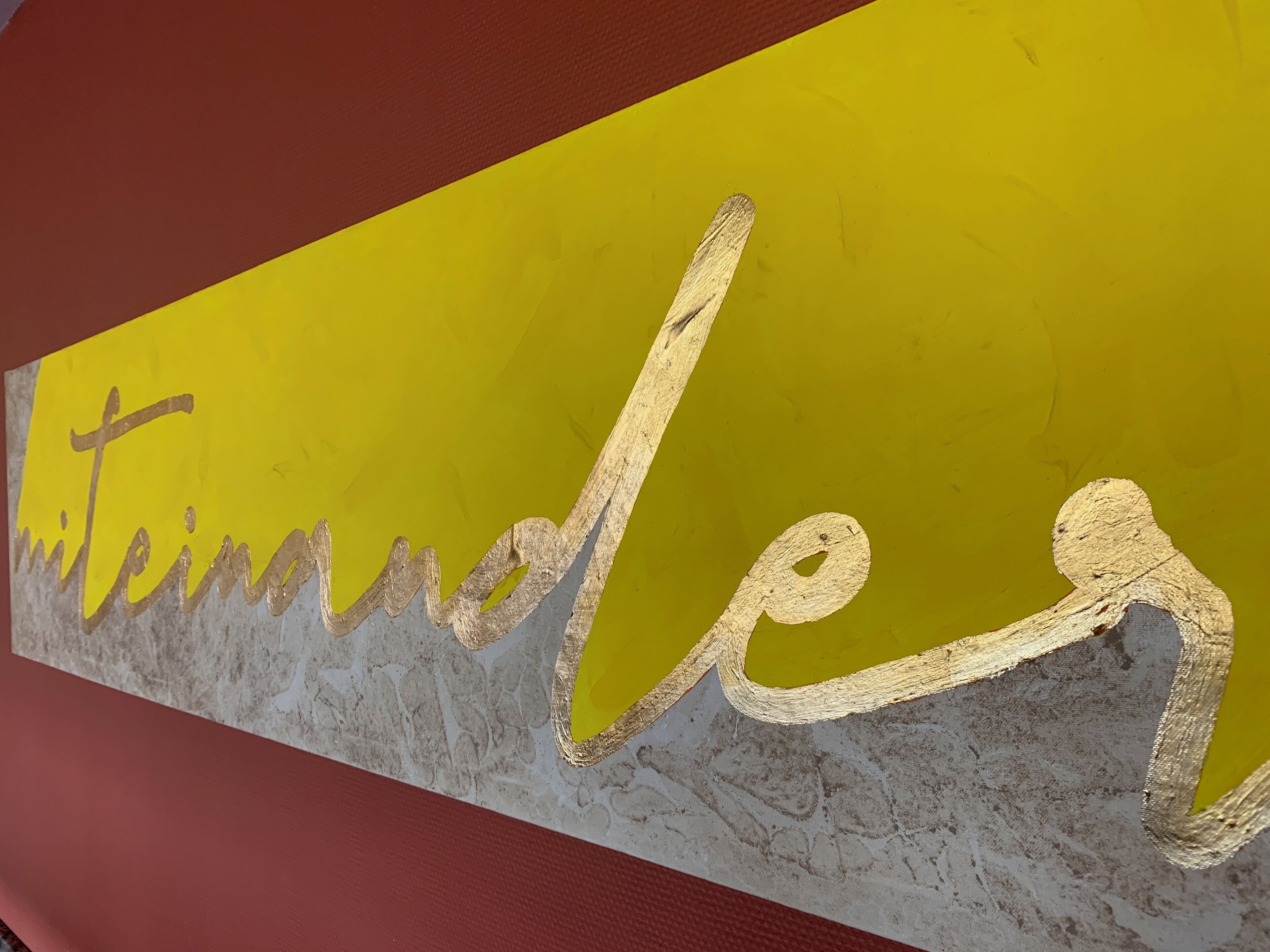 A textured wall with the word "mittenadel" in a cursive font.