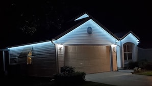 A house with a garage, a staircase, and a small porch area.