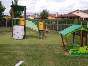 A playground with climbing structures and a small shelter.