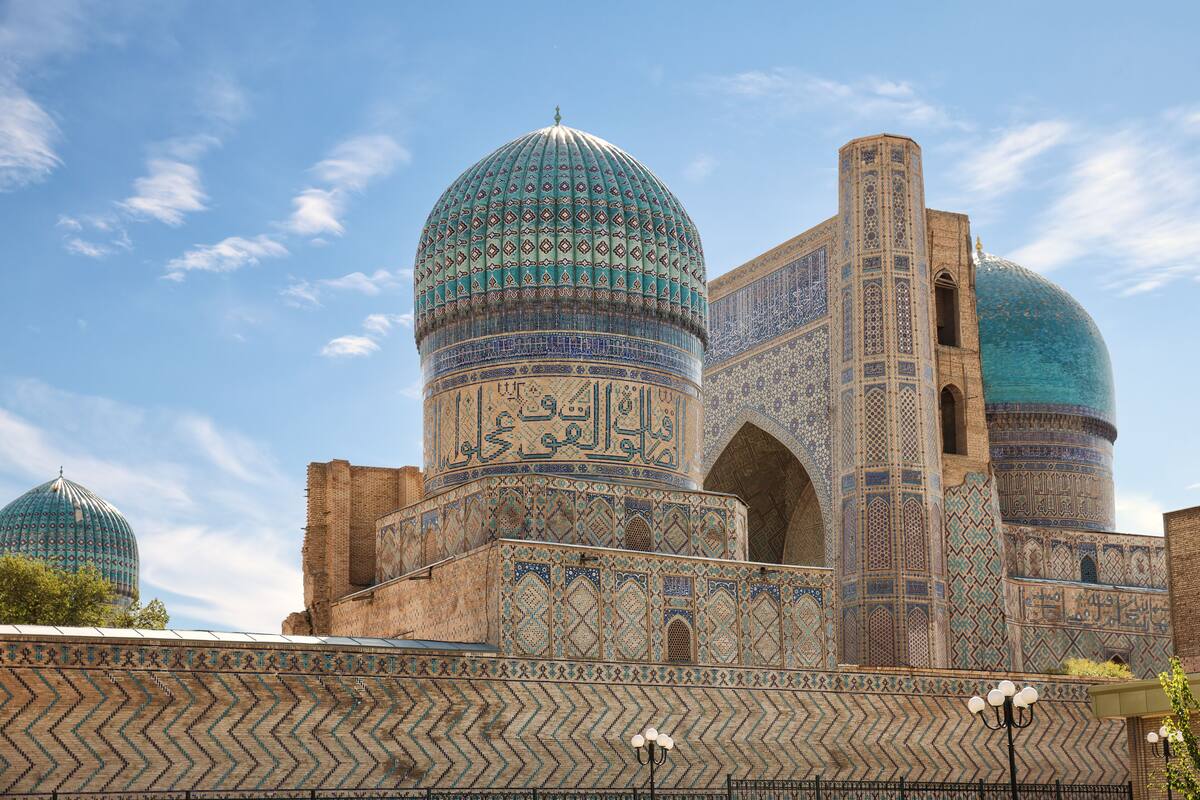 A historic building with large domes and intricate tile work.