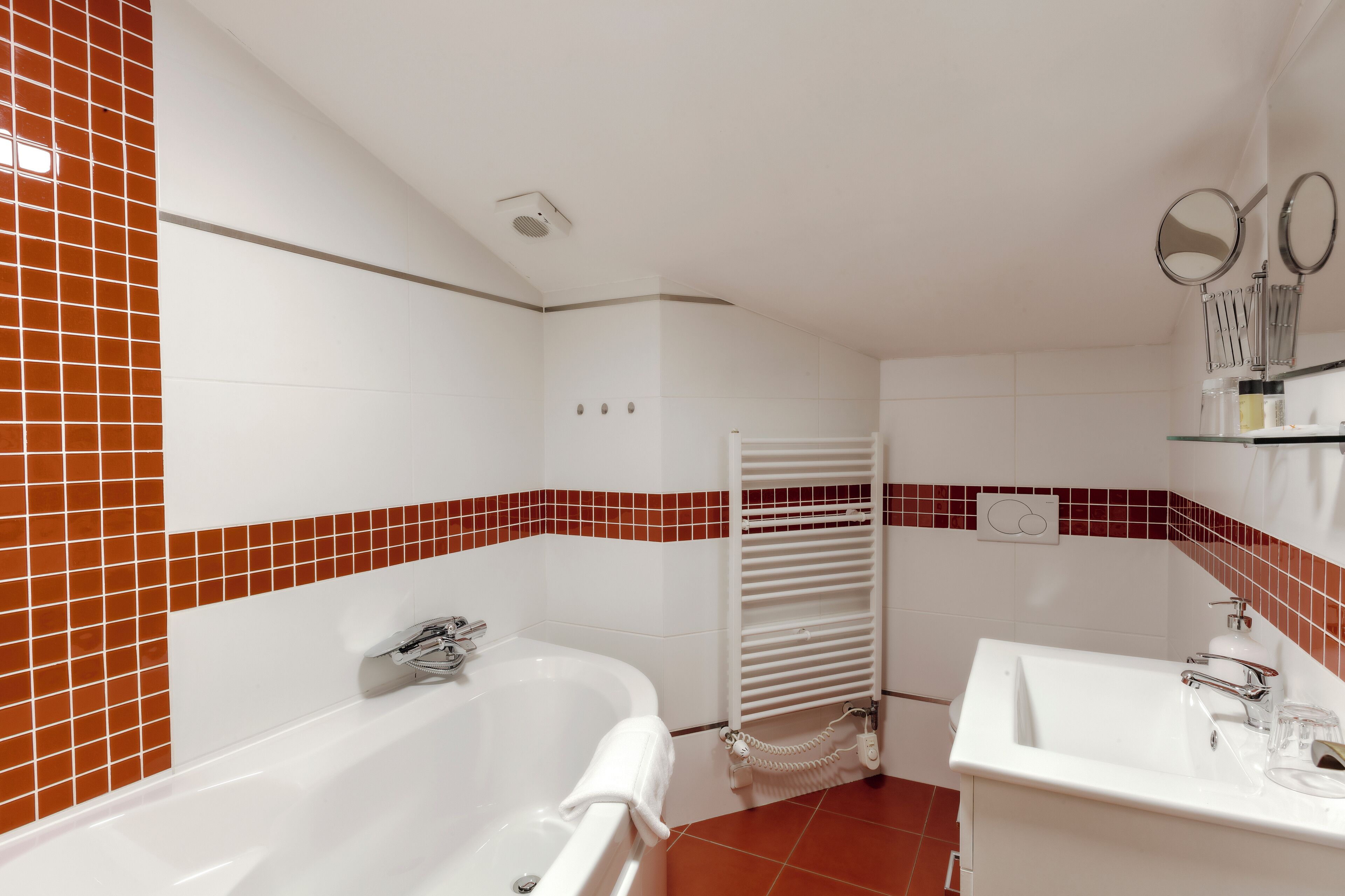 A bathroom with a bathtub, a sink, and a shower.