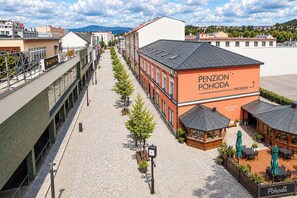 A building with a sign reading 'PENZION POHODA' and a reception area with outdoor seating. - Penzion Pohoda (Trutnov)