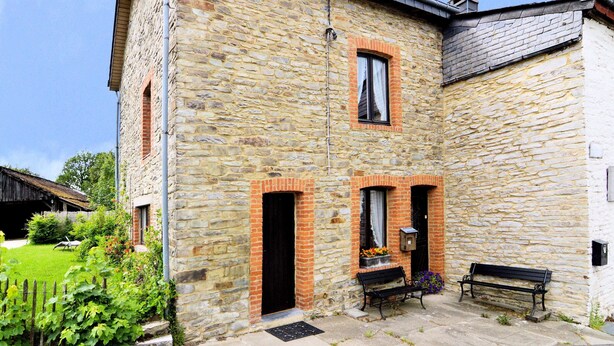 A stone building with a courtyard, a bench, and a small garden area. - Comfortable Villa, Paliseul (Paliseul)