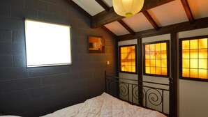 A bedroom with a large bed, a window with a view, and a ceiling light fixture. - Amazing Holiday Home in Stavelot With Terrace (Stavelot)