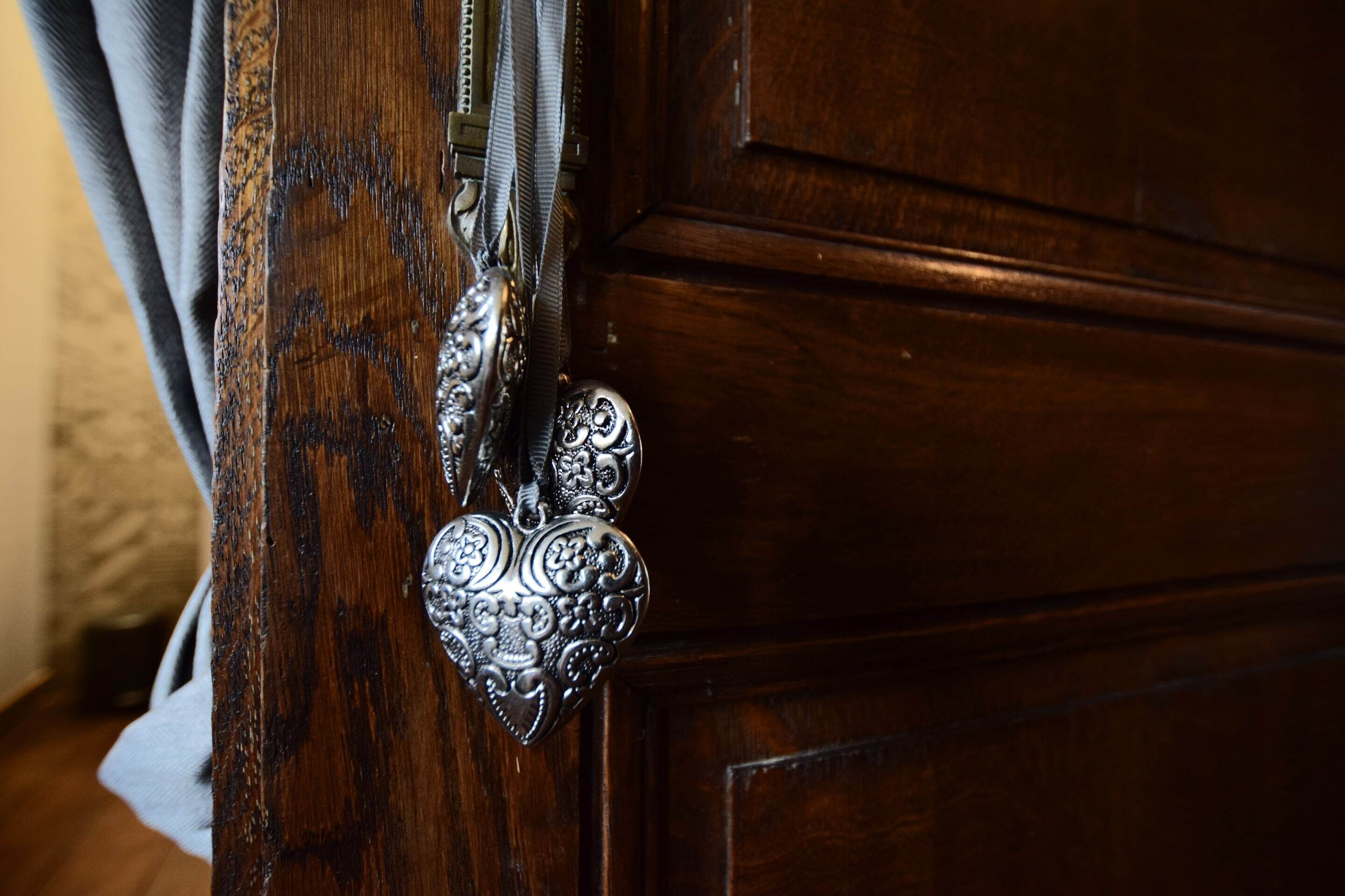 A wooden door with a metal handle and a decorative metal plate.