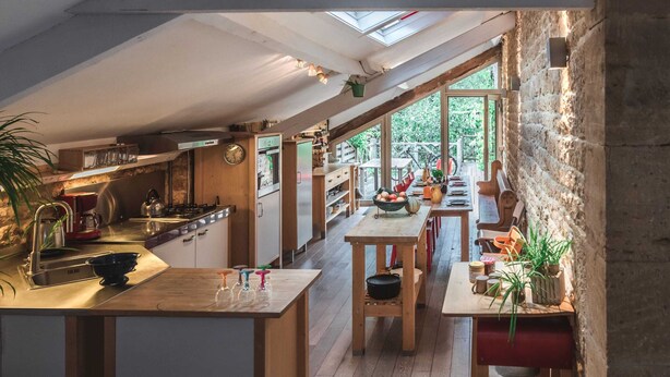 A modern kitchen with wooden countertops, a built-in stove, and a large window overlooking a garden. - Fairytale Escape in Lamorteau (Rouvroy)