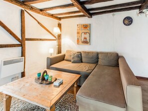 Relax in a traditional room with a sofa, table, and wall-mounted lamp.