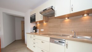 A modern kitchen with a built-in dishwasher, a microwave, and a coffee maker. - Spacious Apartment in Uderns near Ski Area (Uderns)