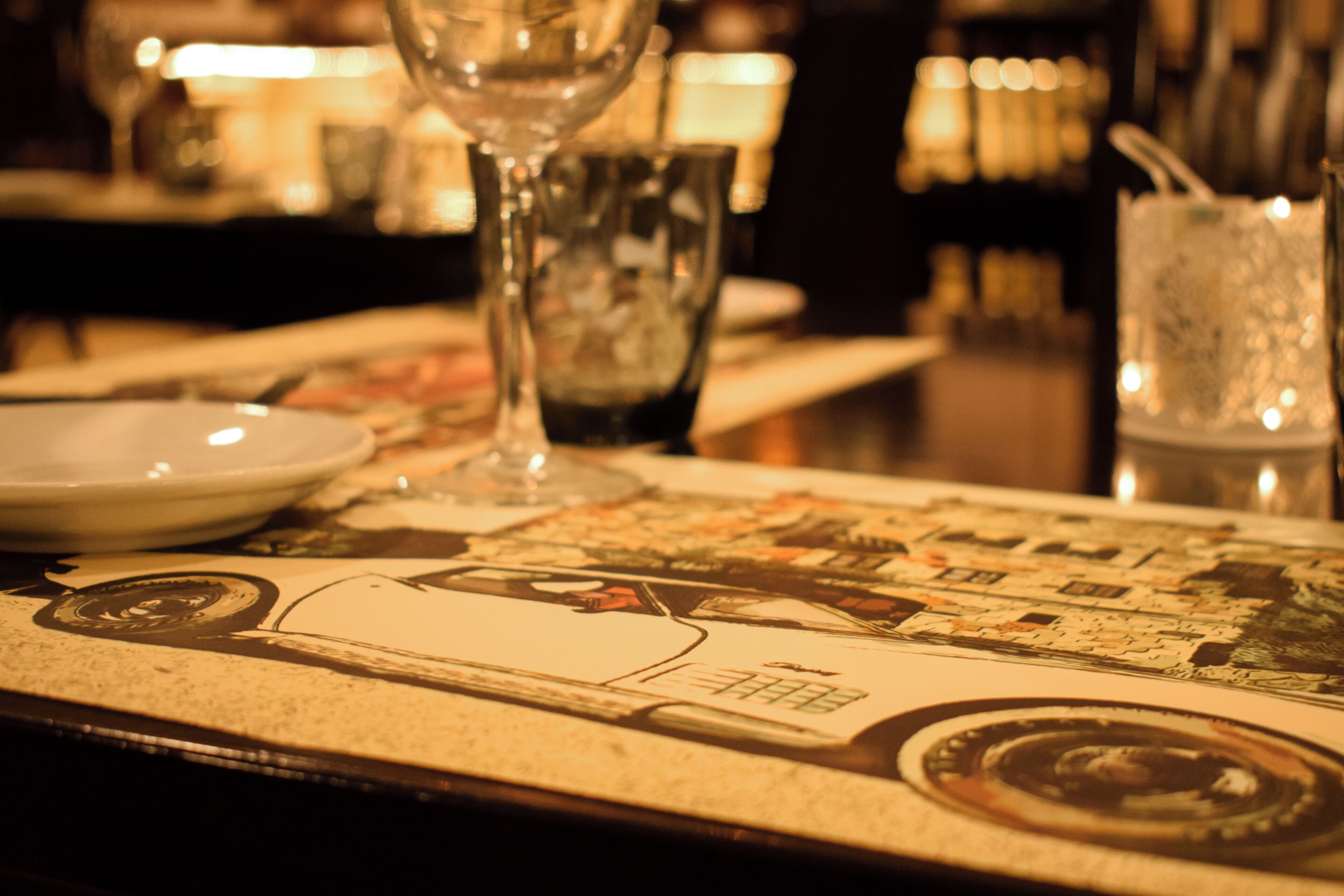 A bar area with a menu, glasses, and a bottle.