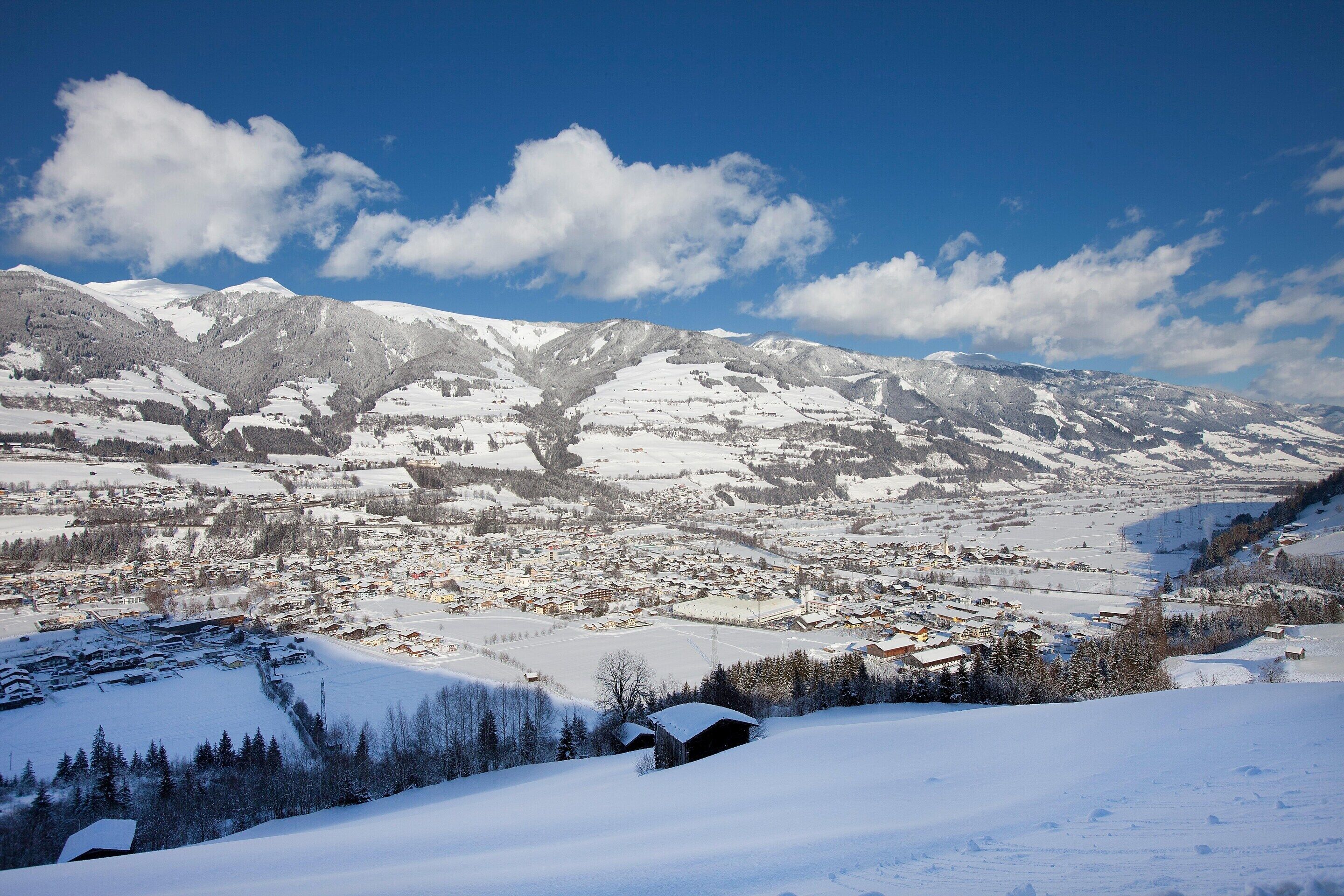 A snow-covered mountain landscape with a town in the valley.