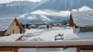 A snow-covered village with traditional houses and a mountain backdrop. - Spacious Chalet in Kötschach-Mauthen near Ski Area (Kotschach-Mauthen)