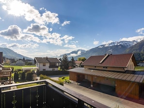 A residential area with houses, a wooden deck, and a mountain backdrop. - Spacious Chalet in Kötschach-Mauthen near Ski Area (Kotschach-Mauthen)