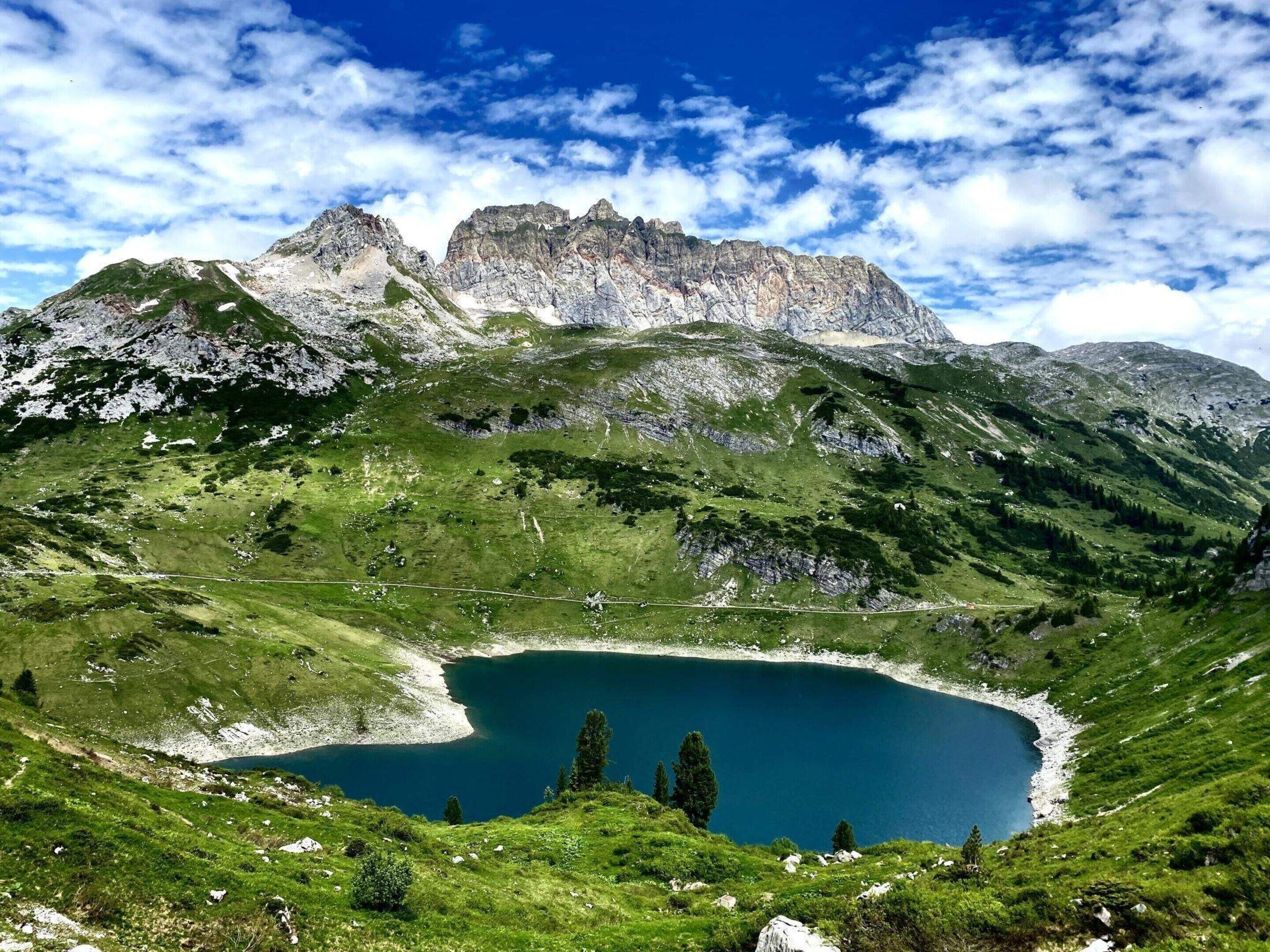 A mountainous landscape with a lake and a clear sky.