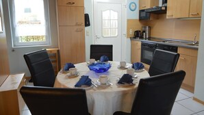 Una cucina compatta con mobili in legno, un forno a microonde e un fornello.