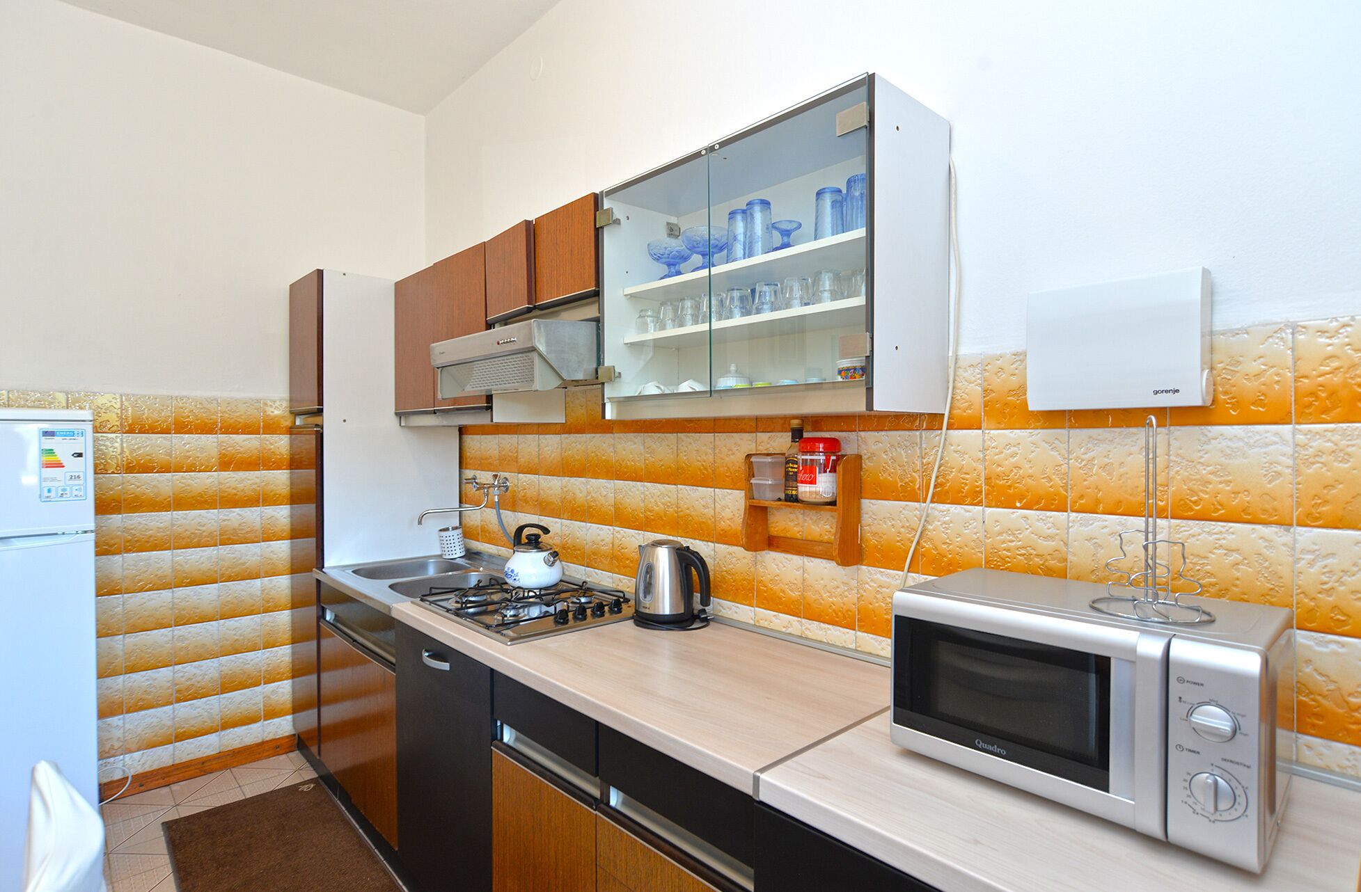 A kitchen with a stove, microwave, and cabinets.